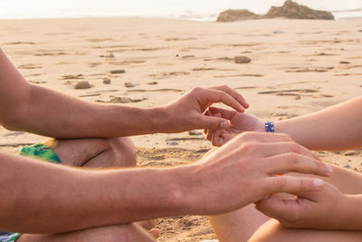 Midsection of people on beach