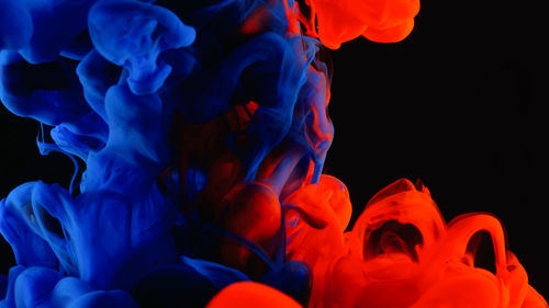 Low angle view of colors splashing in liquid