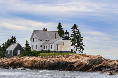 House by sea against sky