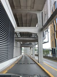 Empty road along bridge in city