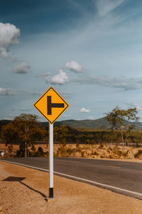 Road sign against sky