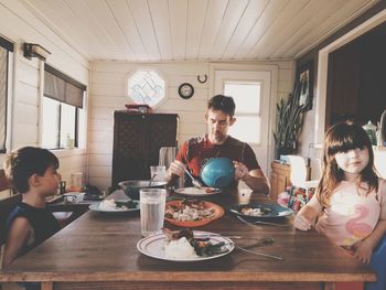 Father with children having lunch at home