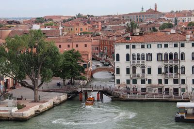 Bridge over canal amidst buildings in city