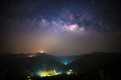 Scenic view of mountains against sky at night