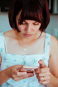 Midsection of woman holding smart phone