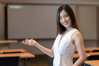 Portrait of young woman standing at home