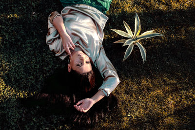 Portrait of young woman on plant