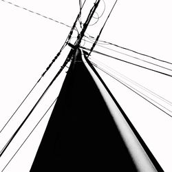 Low angle view of electricity pylon against clear sky