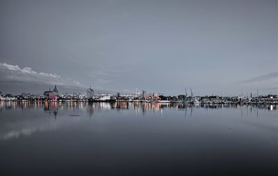 Sailboats in sea against sky