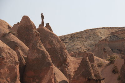 Rocks on mountain against clear sky