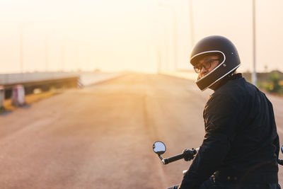 Young man riding big bike motocycle on asphalt high way against, motorbike man has freedom