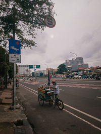 Vehicles on road against buildings in city