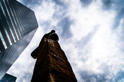 Low angle view of bird perching on building