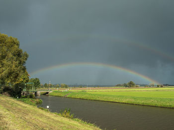 Scenic view of rainbow over field