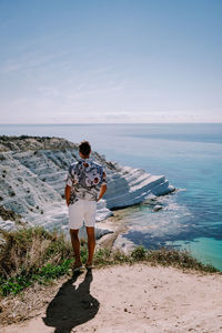 Rear view of woman standing on beach