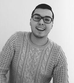 Portrait of smiling young man against white background