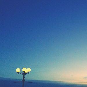 Low angle view of street light against clear blue sky