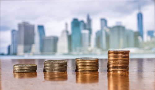 Stack of coins on table in city