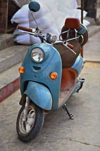 Close-up of motor scooter parked on street