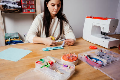 Woman working on table at home