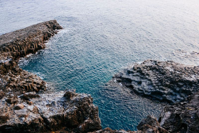 High angle view of rocks by sea