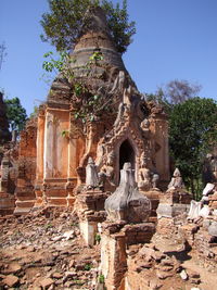 Statue in temple against sky