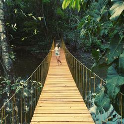 Woman walking on footbridge