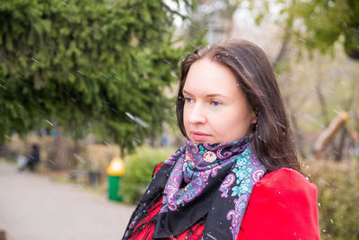 Thoughtful woman during snowfall