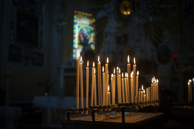 Illuminated candles in temple