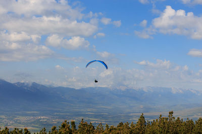 Paragliding flying through the green meadows.sport concept