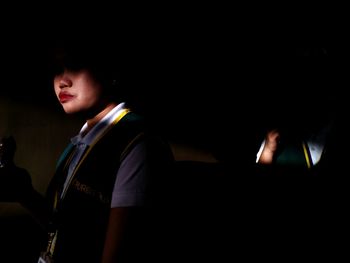 Portrait of boy playing in the dark