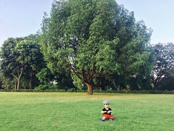 Woman on field by tree