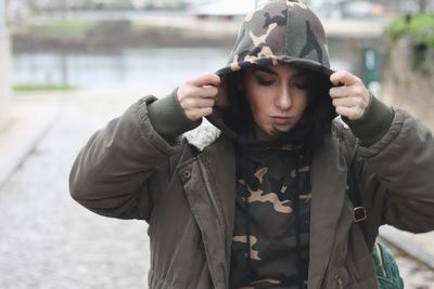 Close-up of beautiful young woman in warm clothes