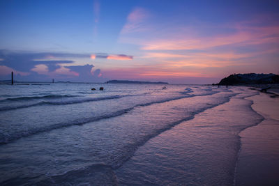 Scenic view of beach against sky during sunset