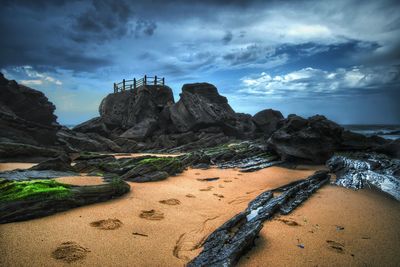 Scenic view of mountains against cloudy sky