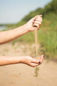 Close-up of hand holding sand