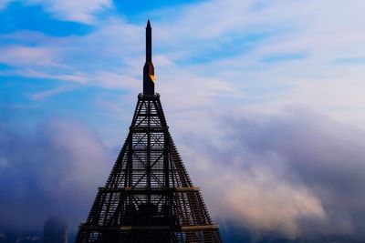 Low angle view of building against cloudy sky