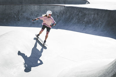 Male athlete skateboarding during sunny day