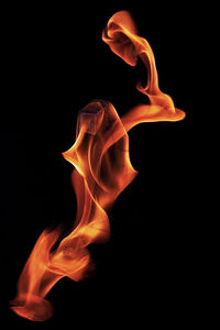 Close-up of flame against black background