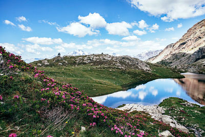 Scenic view of lake and mountains against sky