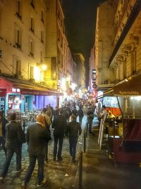 People in illuminated city at night