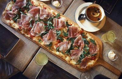 High angle view of pizza served on table