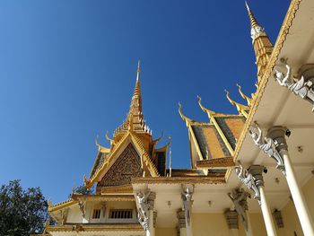 Low angle view of temple building against clear blue sky