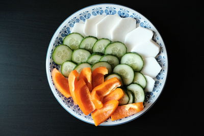 High angle view of chopped fruits in bowl on table