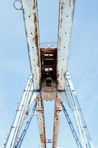 Low angle view of abandoned metallic structure against sky