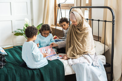 Family on bed at home