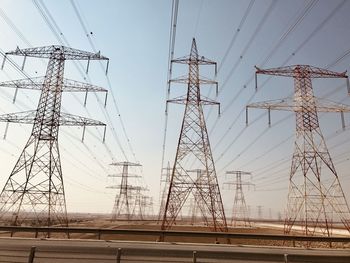 Low angle view of electricity pylon against sky