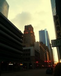 Low angle view of illuminated buildings against sky at dusk