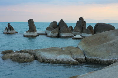 Rocks in sea against sky