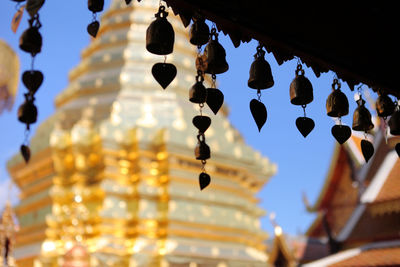 Low angle view of decorations hanging on building against sky